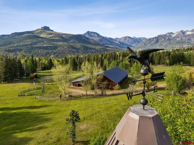 a view of a chairs and table in the balcony