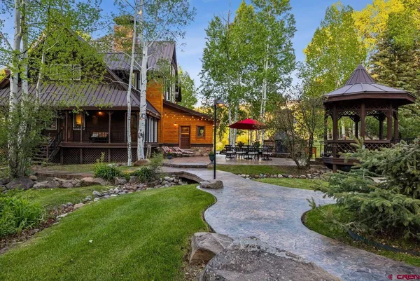 a view of a table and chairs under an umbrella
