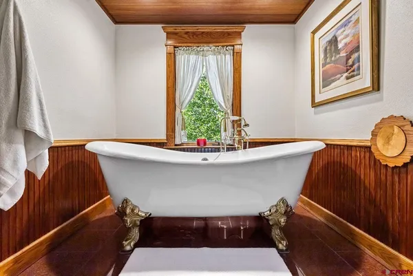 a room with furniture pool table table and a chandelier