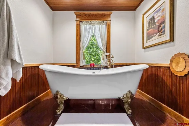 a room with furniture pool table table and a chandelier