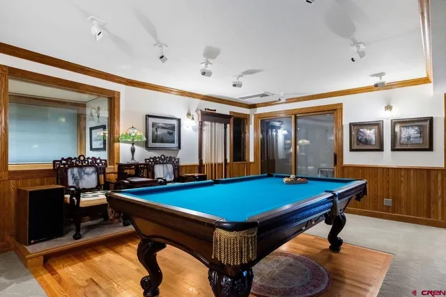 a living room with furniture a fireplace and a large window