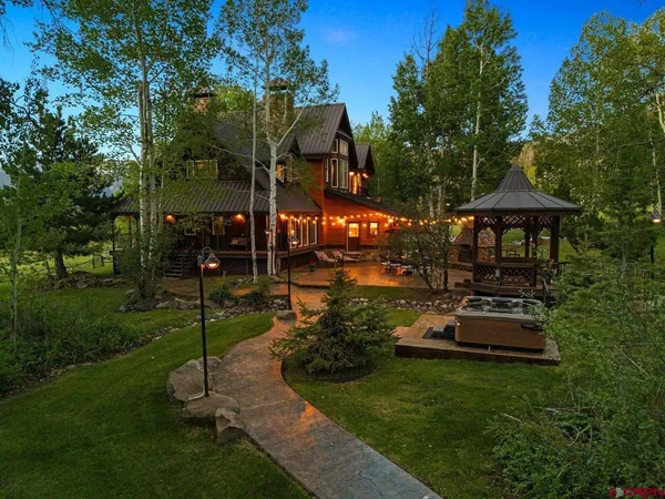 a view of a house with backyard porch and sitting area