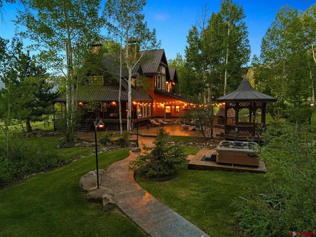 a view of a house with backyard porch and sitting area