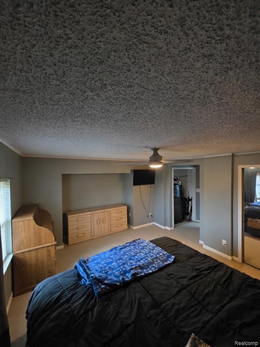 2611 Miller Road Allenton, MI 48002 - Photo 5 of 41 Recessed wall feature, ceiling-mounted light fixture with fan, wall-to-wall carpeting, window with horizontal blinds, mirrored closet doors