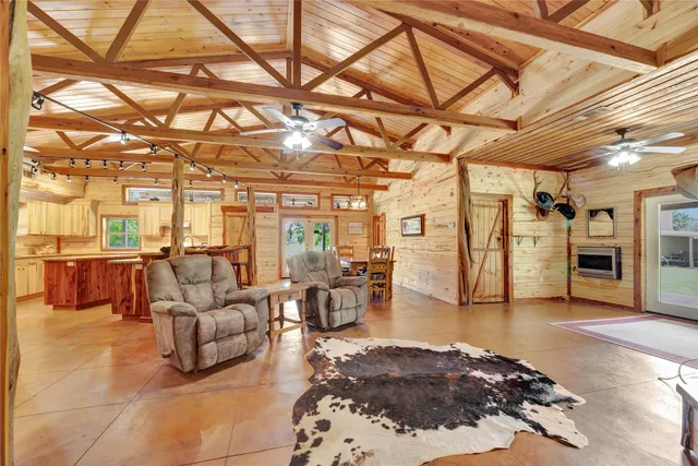 a living room with lots of furniture and a rug