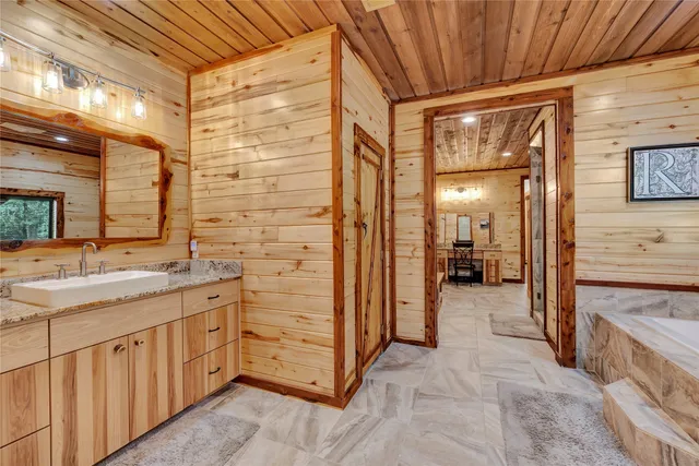 a bathroom with a granite countertop sink mirror and