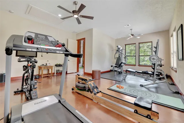 a room with gym equipment and windows