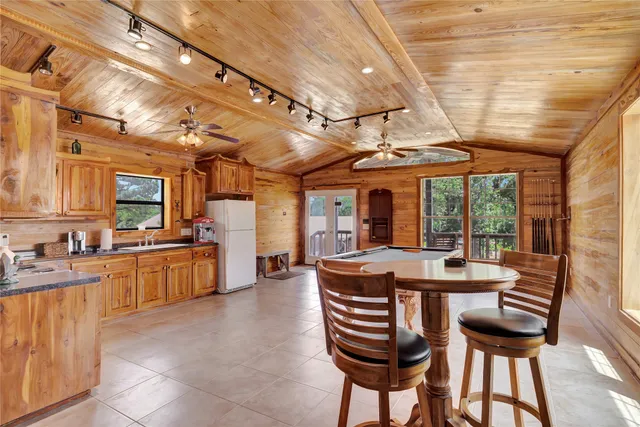 a dining room with furniture a chandelier and wooden floor