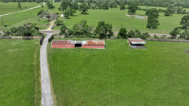 an aerial view of a house with outdoor space lake view and outdoor seating
