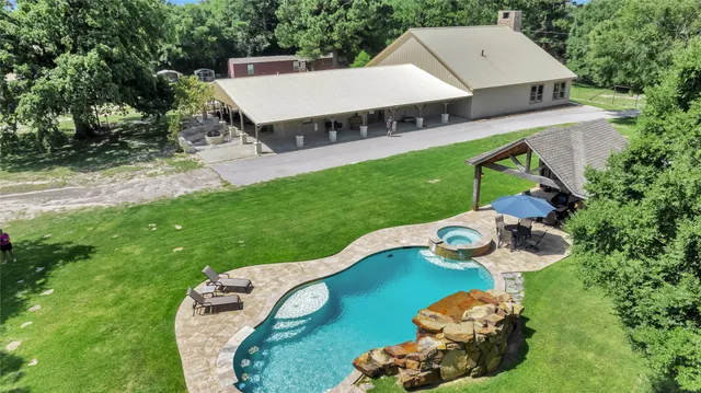 an aerial view of a house with backyard space and balcony