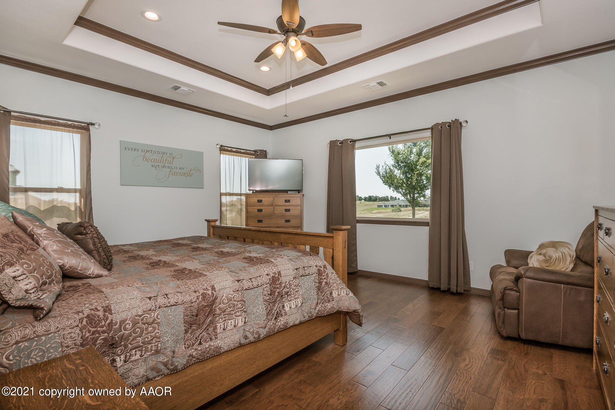 17500 Spring Lake Drive Canyon, TX 79015 - Photo 16 of 49 a bedroom with a large bed and a flat tv screen