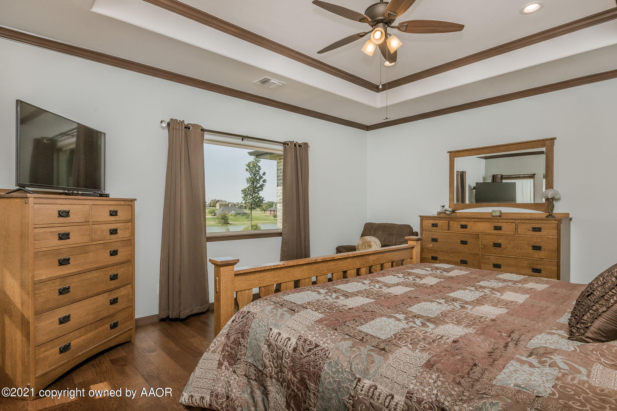 17500 Spring Lake Drive Canyon, TX 79015 - Photo 17 of 49 a bedroom with a bed and a flat tv screen on dresser