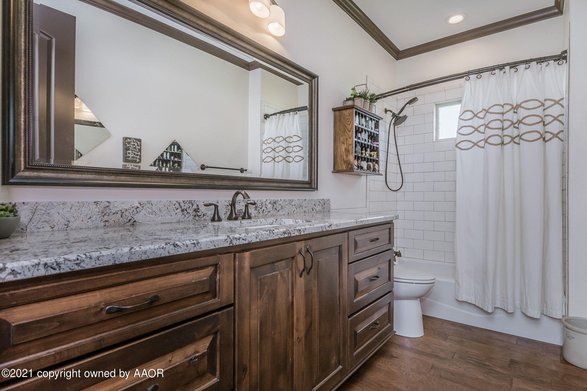 17500 Spring Lake Drive Canyon, TX 79015 - Photo 25 of 49 a bathroom with a granite countertop sink a toilet and a mirror