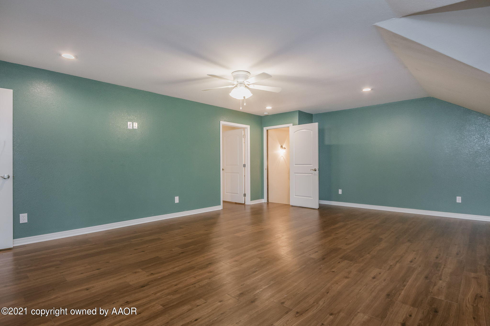 17500 Spring Lake Drive Canyon, TX 79015 - Photo 31 of 49 a view of an empty room with wooden floor and a ceiling fan