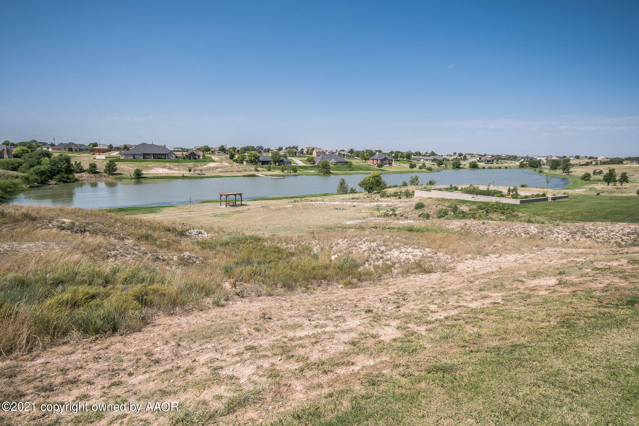 17500 Spring Lake Drive Canyon, TX 79015 - Photo 41 of 49 a view of a lake with houses in the background