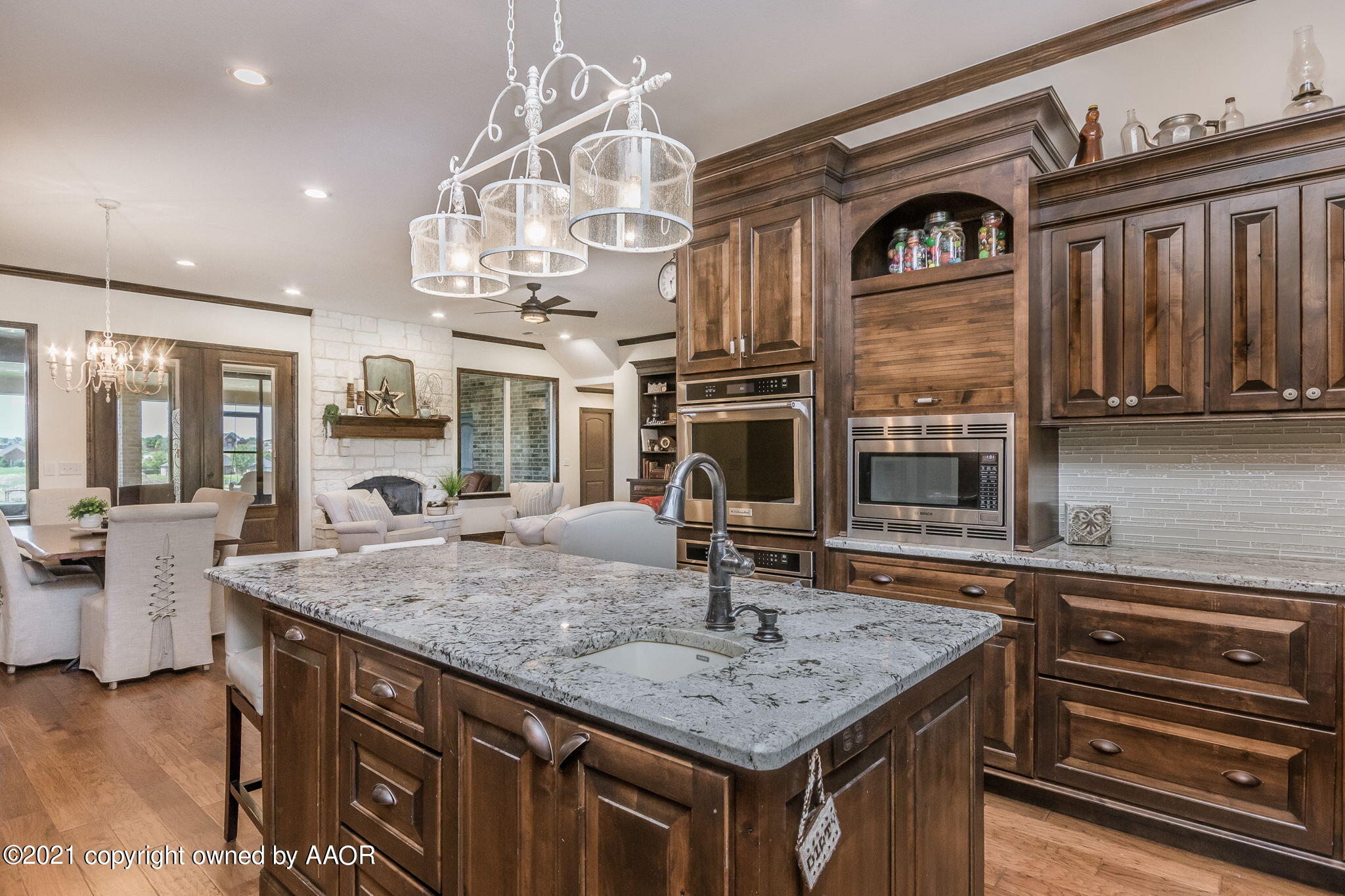 17500 Spring Lake Drive Canyon, TX 79015 - Photo 9 of 49 a kitchen with cabinets and chandelier