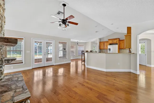 a view of a kitchen with furniture and wooden floor