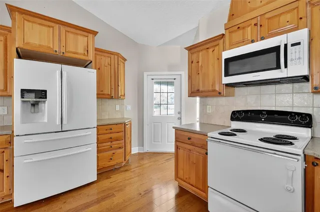 a kitchen with stainless steel appliances a stove microwave and a refrigerator