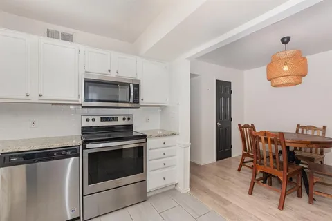 a kitchen with stainless steel appliances a stove a microwave and a refrigerator