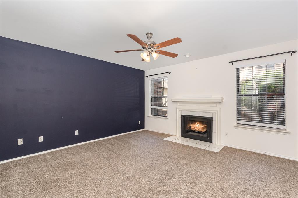 8750 Park Lane, Unit 151 Dallas, TX 75231 - Photo 20 of 33 a view of a livingroom with a fireplace and a ceiling fan