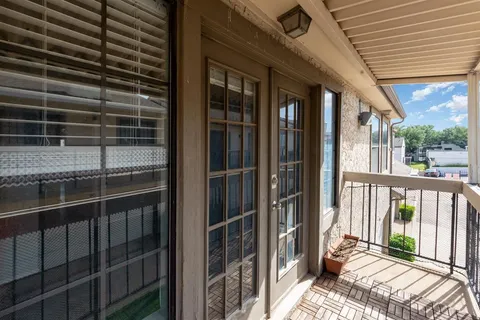 a view of balcony with floor to ceiling window and wooden floor