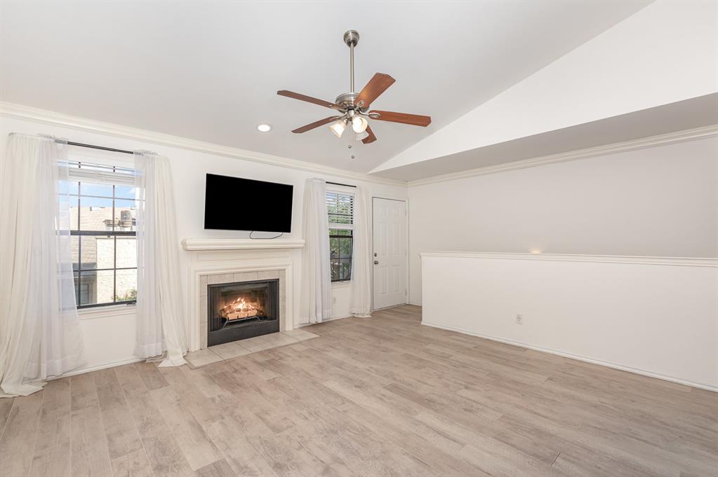 8750 Park Lane, Unit 151 Dallas, TX 75231 - Photo 5 of 33 a view of empty room with fireplace and fan