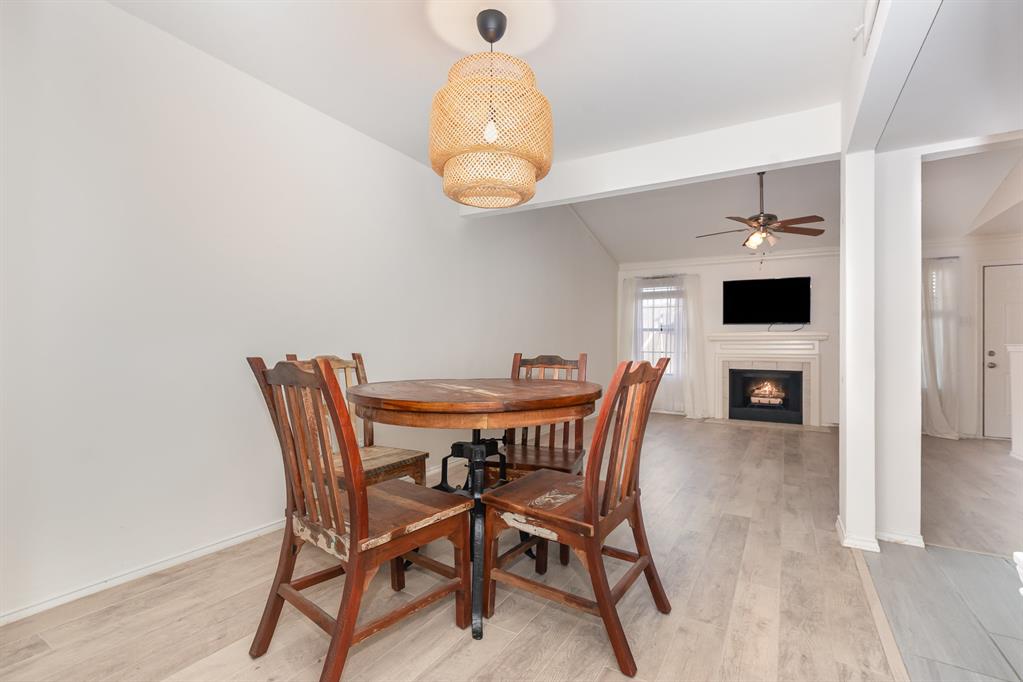 8750 Park Lane, Unit 151 Dallas, TX 75231 - Photo 10 of 33 a view of a dining room with furniture and wooden floor