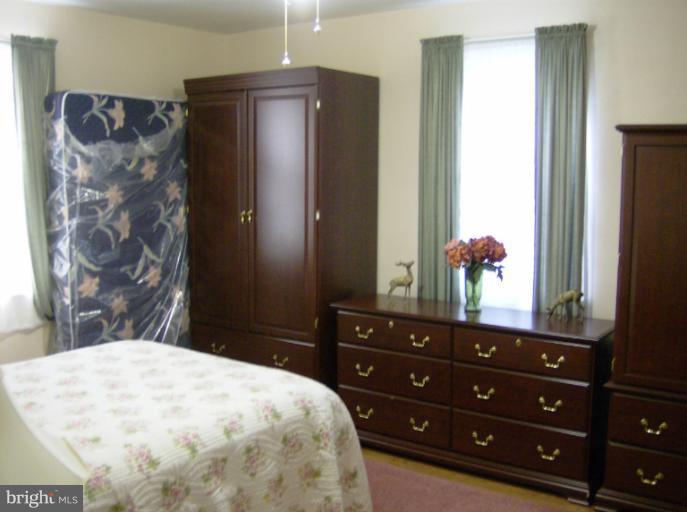 296 Upperlanding Road Essex, MD 21221 - Photo 3 of 13 a bedroom with a bed and a dresser