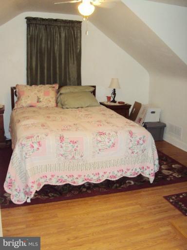 296 Upperlanding Road Essex, MD 21221 - Photo 6 of 13 a large bed sitting in a bedroom next to a cabinet