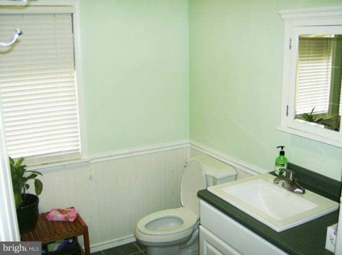 296 Upperlanding Road Essex, MD 21221 - Photo 8 of 13 a bathroom with a sink a toilet and a window