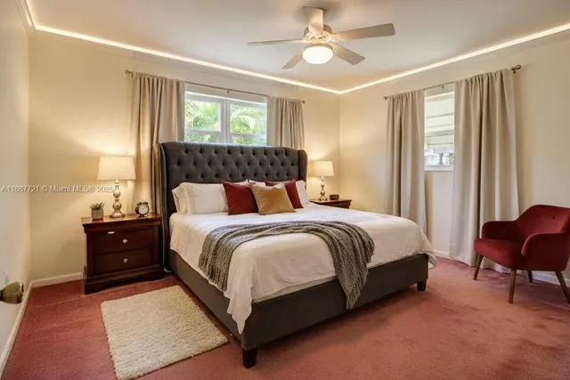 a spacious bedroom with a bed and chair