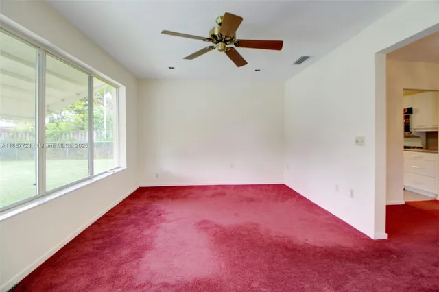 a view of empty room with ceiling fan
