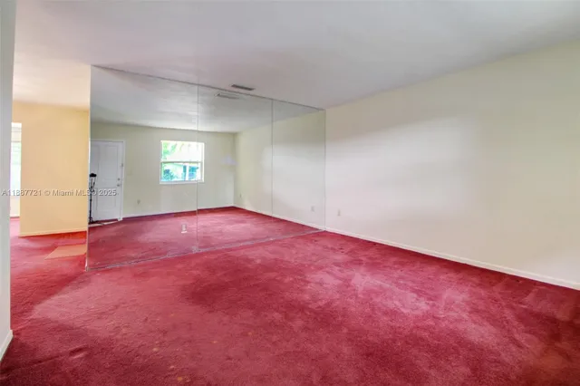 an empty room with a window and a fireplace