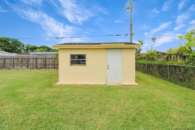 a view of a backyard with plants and a lake view