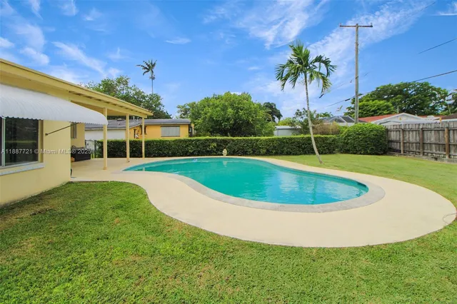 a view of a swimming pool with a yard