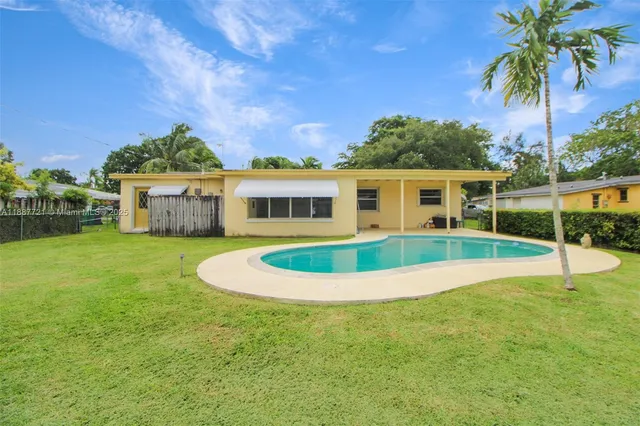 a house with swimming pool in front of it