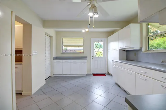 a kitchen with granite countertop a stove a sink and a refrigerator