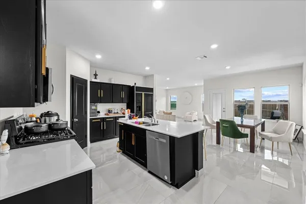 a kitchen with a sink and stove top oven