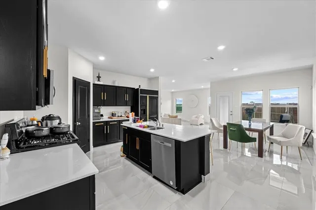 a kitchen with a sink and stove top oven
