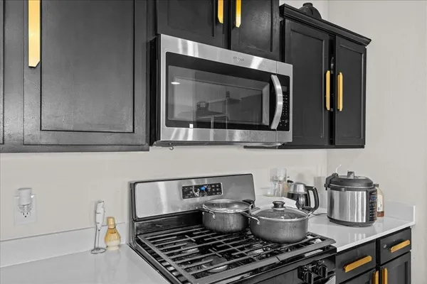 a kitchen with a stove and a microwave