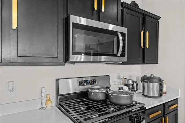 a kitchen with a stove and a microwave