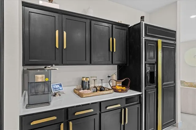 a kitchen with stainless steel appliances granite countertop a refrigerator and a sink