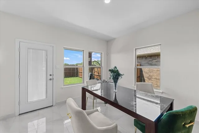 a view of a dining room with furniture and a potted plant
