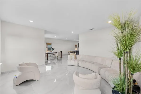 a living room with furniture and a potted plant