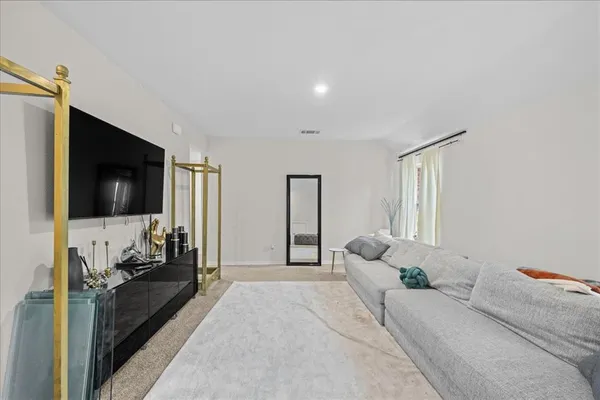 a bedroom with a large bed and a flat screen tv