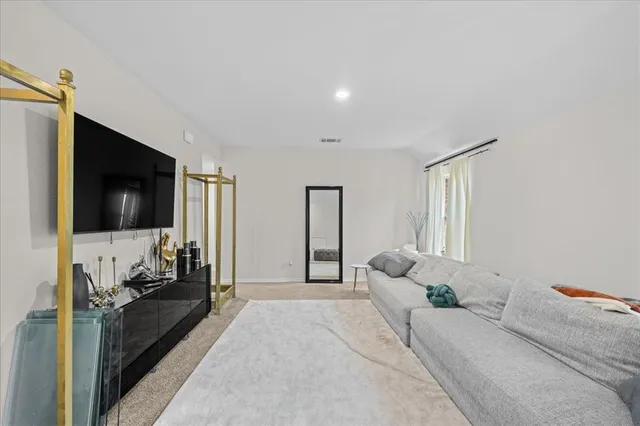 a bedroom with a large bed and a flat screen tv