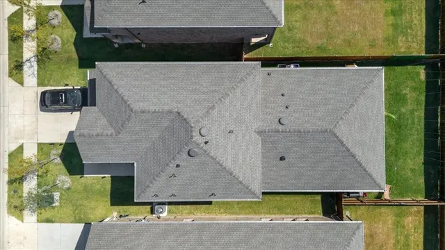 an aerial view of a house with a yard