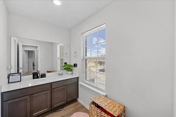 a spacious bathroom with a double vanity sink a mirror and a shower