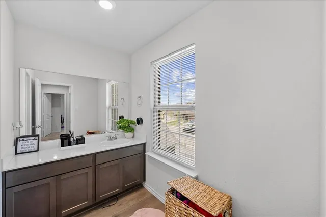 a spacious bathroom with a double vanity sink a mirror and a shower