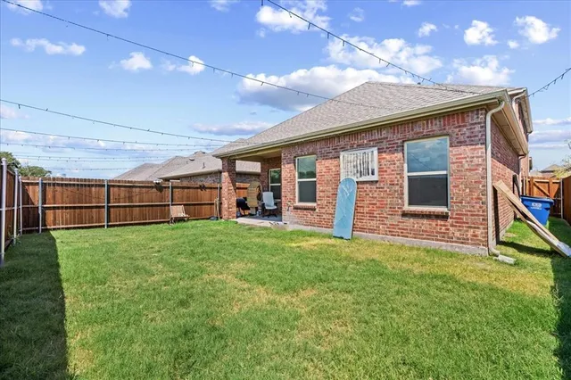 a view of a backyard with plants and a garden